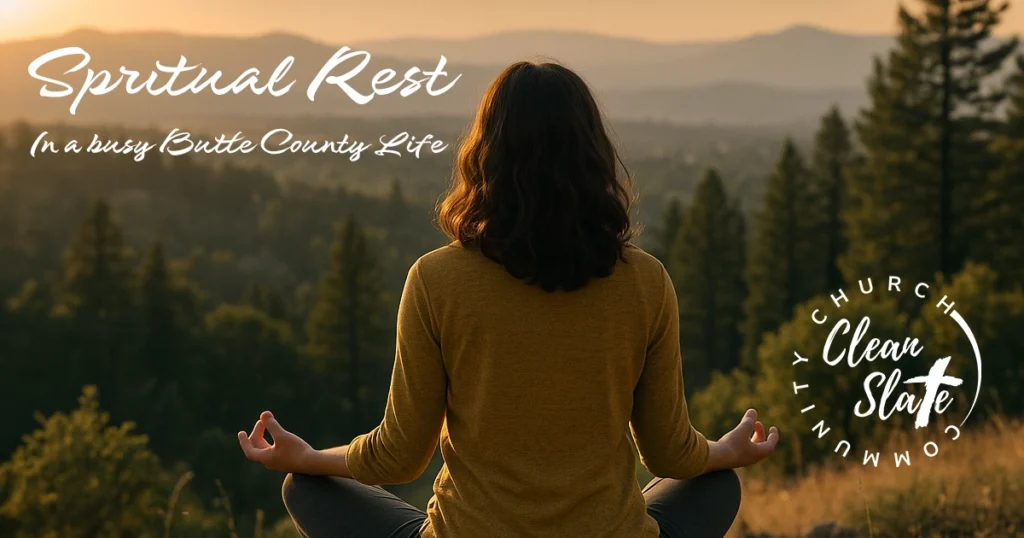 A person sits cross-legged meditating outdoors at sunset, overlooking a forest and mountains, with text promoting spiritual rest and Clean Slate Community Church.